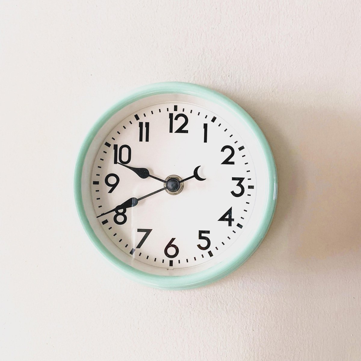 An image of an analogue clock hanging on a wall